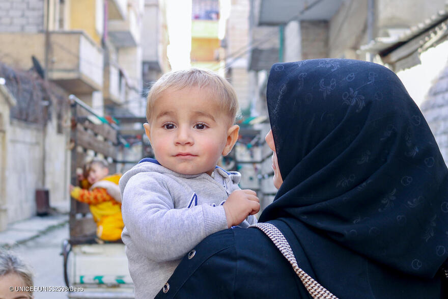 Abd Alwahab, de 3 años, y su madre Manal, en el exterior de un centro de salud y nutrición apoyado por UNICEF en Nayrab, ciudad de Alepo, Siria, el 12 de febrero de 2024.