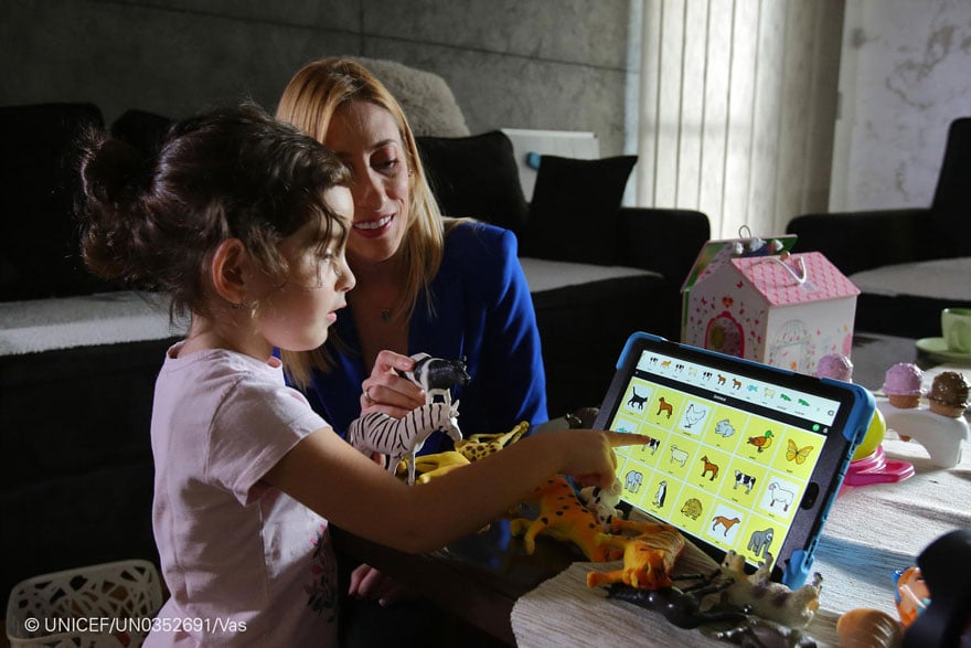 Una niña hace uso de una tablet con material educativo