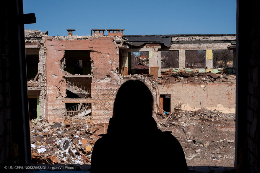 Una adolescente observa los restos una escuela que había servido como refugio civil y base logística antes de ser destruida por un ataque aéreo.