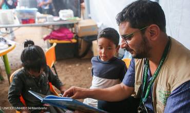 Óscar Maradiaga (dereita), especialista en protección, atende a nenos migrantes en Danlí, O Paraíso, na parte oriental do país centroamericano. © UNICEF/UNI480134/Membreño
