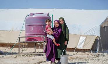 Niñas sirias recogiendo agua de uno de los depósitos instalados con el apoyo de UNICEF