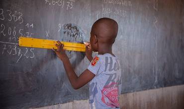 Un alumno utiliza una regla en la pizarra en clase, en una escuela pública de Kaya, Región Centro Norte, Burkina Faso.
