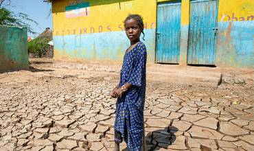 Chica en un suelo seco y agrietado