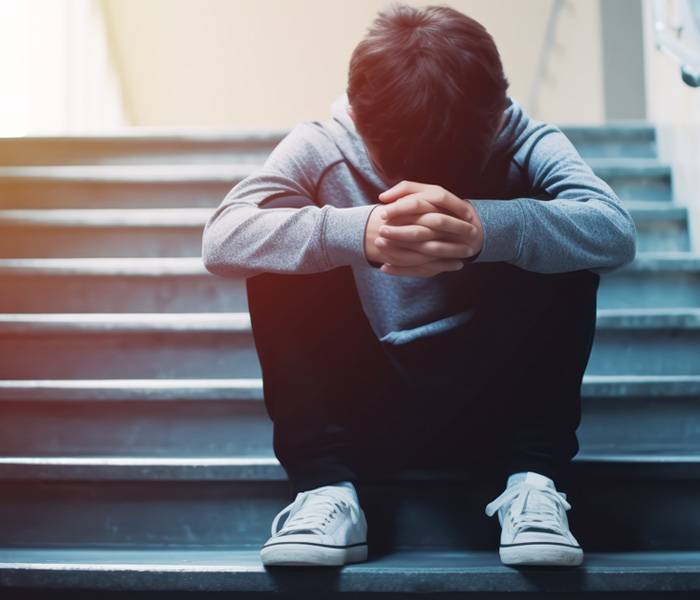 Un niño sentado en unas escaleras