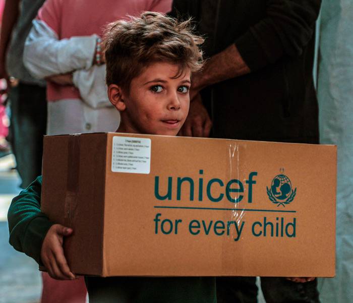 Distribución de paquetes de ropa de invierno en el Centro de Programas para Mujeres en el oeste de la ciudad de Gaza.