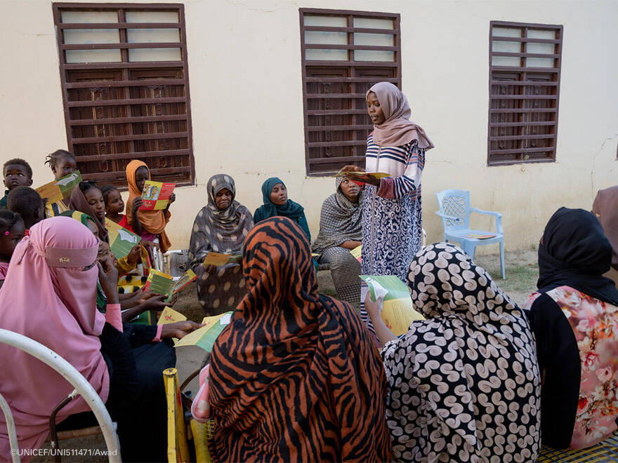 Las chicas de la comunidad escuchan atentamente las palabras de Halima. Halima habla con varias chicas.