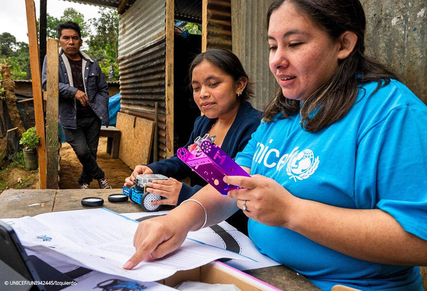 Adriana y Joselin revisan los componentes del robot para montarlo y poder enseñárselo a su familia. Adriana y Joselin revisan los componentes del robot