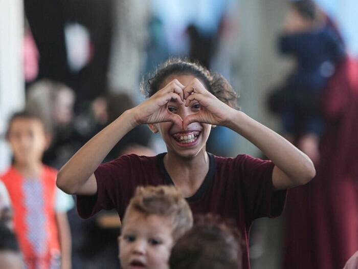 Amal posa haciendo un gesto en forma de corazón con sus manos