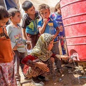 Niños alrededor de una toma de agua